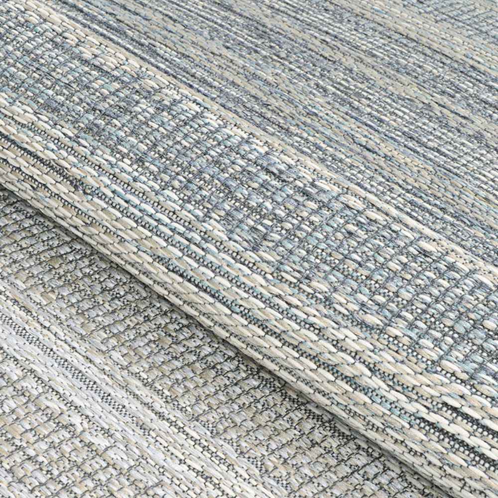 A close-up view of the Couristan Cape Indoor/Outdoor Rug - Shallows/Taupe-Grey shows its textured woven pattern with interlaced taupe and grey tones