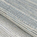 A close-up view of the Couristan Cape Indoor/Outdoor Rug - Shallows/Taupe-Grey shows its textured woven pattern with interlaced taupe and grey tones