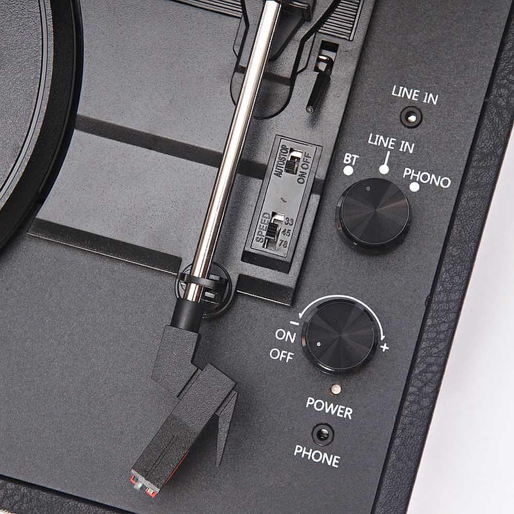 A close-up view of the control knobs and stylus arm of the Arkrocket Curiosity Suitcase Bluetooth Turntable (Black)