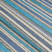 A close-up view reveals the textured, tightly woven fabric of the Couristan Cape Indoor/Outdoor Rug - Brockton/Cobalt-Teal with alternating stripes of blue, teal, and ivory