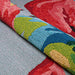 A close-up view reveals the textured loops and vibrant colors of the Couristan Covington Indoor/Outdoor Rug - Flamingos/Multi