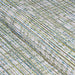 A close-up view shows the intricate woven texture and streaked pattern of the Couristan Cape Indoor/Outdoor Rug - Falmouth/Ivory-Hunter in green, ivory, and blue tones