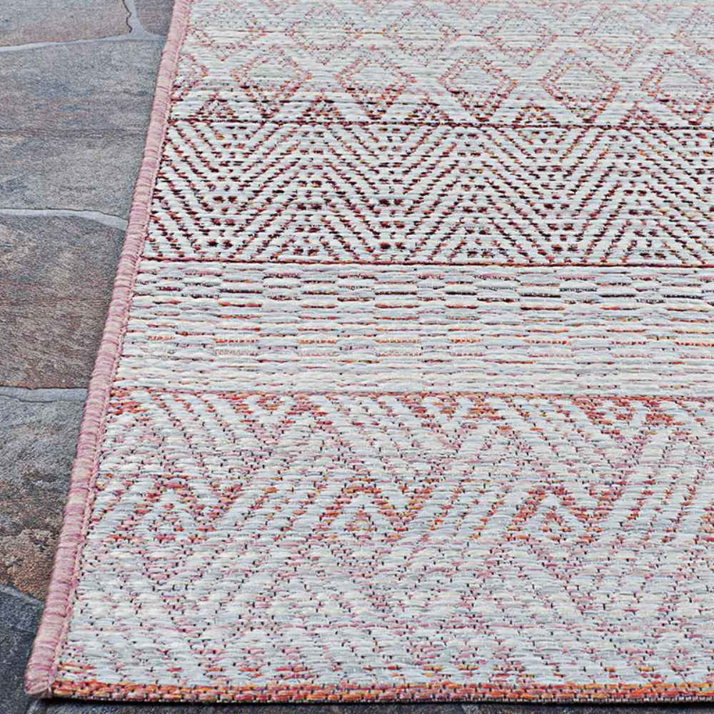 A close corner shot of the Couristan Cape Indoor/Outdoor Rug - Gables/Hibiscus showcases the rug’s precise stitching and mix of repeating tribal-inspired patterns