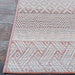 A close corner shot of the Couristan Cape Indoor/Outdoor Rug - Gables/Hibiscus showcases the rug’s precise stitching and mix of repeating tribal-inspired patterns