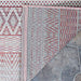 A corner of the Couristan Cape Indoor/Outdoor Rug - Gables/Hibiscus is flipped over to display the backside weave and clean edging details