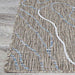A corner of the Couristan Charm Indoor/Outdoor Rug - Odessa/Twig is displayed on light wood flooring