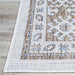 A corner of the Couristan Charm Indoor/Outdoor Rug - Woodburn/Ivory-Sand displays its tightly stitched edge and clean finish on hardwood flooring