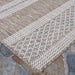 A corner of the Couristan Charm Indoor/Outdoor Rug - Yukon/Twig displays clean edges and a balanced blend of tan, ivory, and soft blue