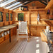 A cozy interior setup in the Outdoor Living Today 8×12 Sunshed Garden Shed features a white rocking chair, hanging tools, and wooden shelves