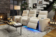 A cozy living room setup features Valencia Natalie Home Theater Seating in beige leather with blue LED lighting