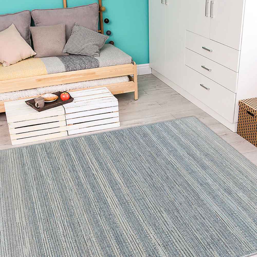 A cozy modern room with a daybed and crate-style coffee table features the Couristan Cape Indoor/Outdoor Rug - Shallows/Taupe-Grey neatly spread across the wooden floor