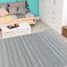 A cozy modern room with a daybed and crate-style coffee table features the Couristan Cape Indoor/Outdoor Rug - Shallows/Taupe-Grey neatly spread across the wooden floor