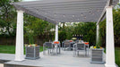 A cozy outdoor dining area features string lights draped across a gray Structureworks Trex Pergola with white posts