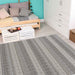 A cozy room features the Couristan Cape Indoor/Outdoor Rug - Torrent/Sky Blue-Grey with subtle striped patterns adding texture to the light wood floor