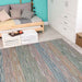 A cozy room with a daybed, teal wall, and white furniture features the Couristan Cape Indoor/Outdoor Rug - Fayston/Multi on the light wood floor