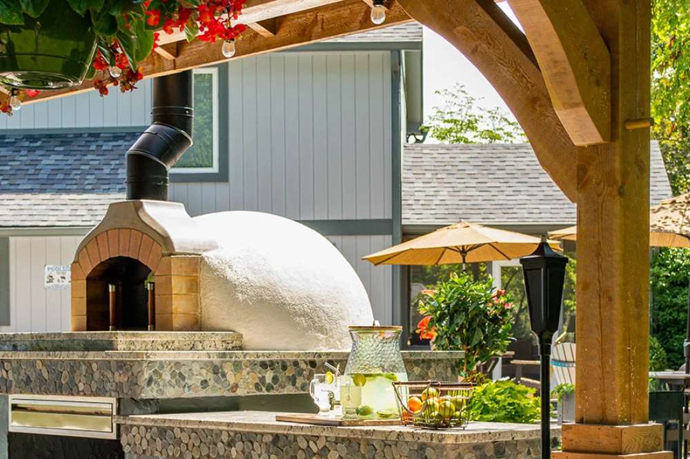 A detailed close-up of the Brookside Timber Frame Forest Melody Pavilion's built-in pizza oven