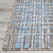 A detailed corner of the Couristan Charm Indoor/Outdoor Rug - Ohe/Sand-Ivory highlights the neatly finished edge and tightly stitched pattern