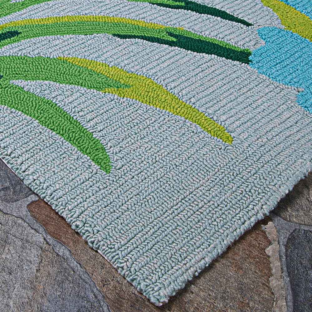 A detailed corner shot of the Couristan Covington Indoor/Outdoor Rug - Flamingos/Multi displays the dense tufted loops and vivid green leaf design