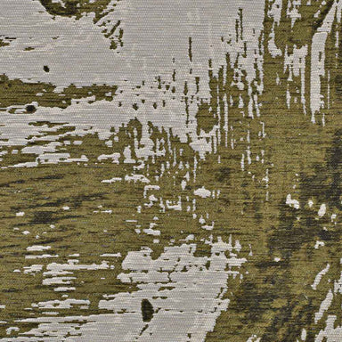 A detailed section of the Couristan Castille Indoor/Outdoor Rug - Canvas/Tea Leaf displays a mix of olive green and pale canvas tones in a modern, distressed pattern