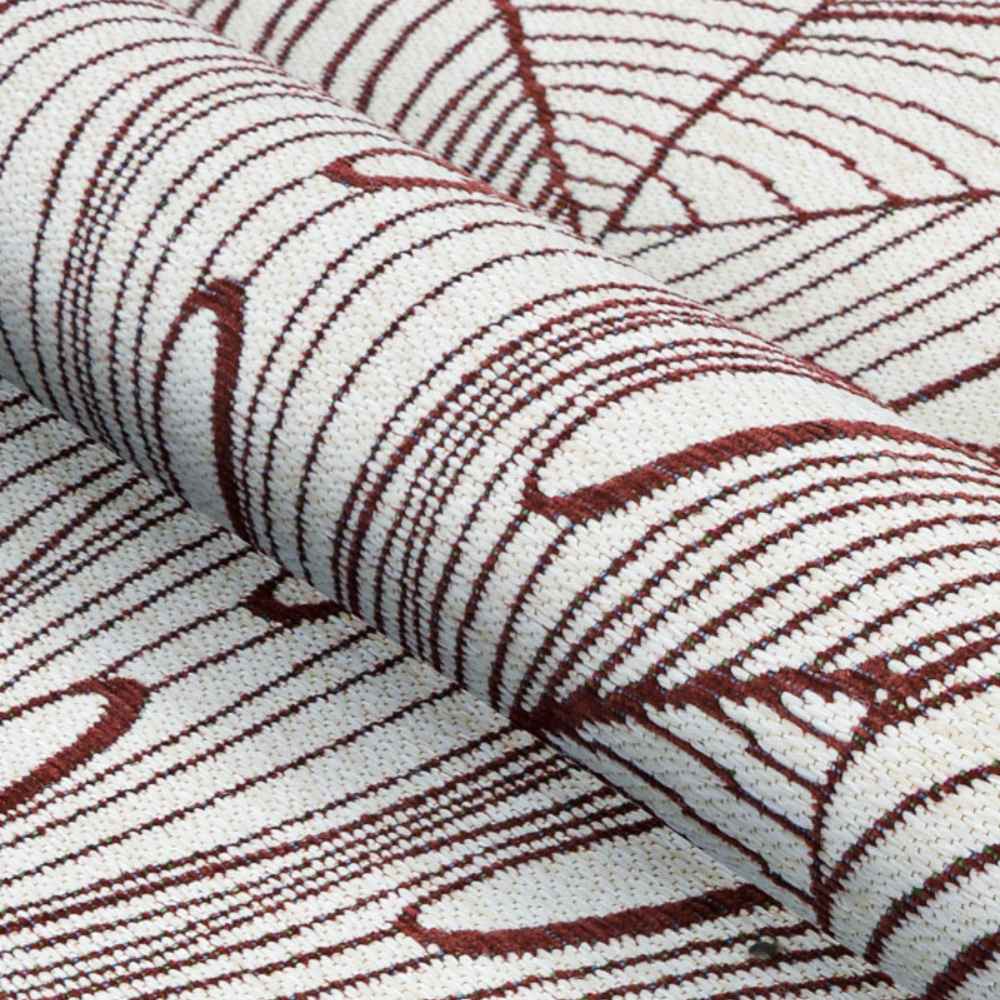 A detailed view of the Couristan Castille Indoor/Outdoor Rug - Palma/Rouge shows its rolled-up texture and flowing leaf-like red line pattern on white