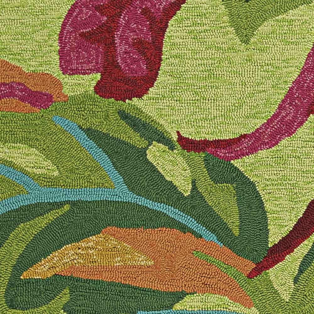 A detailed view of the Couristan Covington Indoor/Outdoor Rug - Painted Fern/Fern-Red reveals intricate stitching and bold botanical shapes in multiple colors