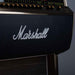 A detailed view of the gold and black control knobs on the Marshall Rocket Full Size LP Jukebox - Black, set against a textured black surface