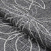 A folded corner of the Couristan Charm Indoor/Outdoor Rug - Botanical/Ash highlights the tightly woven texture and high-quality craftsmanship