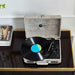 A front-facing shot of Arkrocket Curiosity Suitcase Bluetooth Turntable (Gray Wood Grain) focuses on its built-in speakers and classic suitcase-like structure