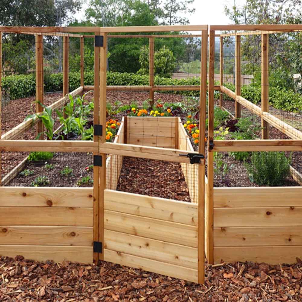 A front view of the Outdoor Living Today 8×12 Raised Garden Bed shows a wooden gate opening to neat rows of vegetables and colorful flowers inside