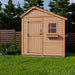 A front view of the Outdoor Living Today 8×8 Sunshed Garden Shed showcases its wooden door, small window, and tidy yard placement