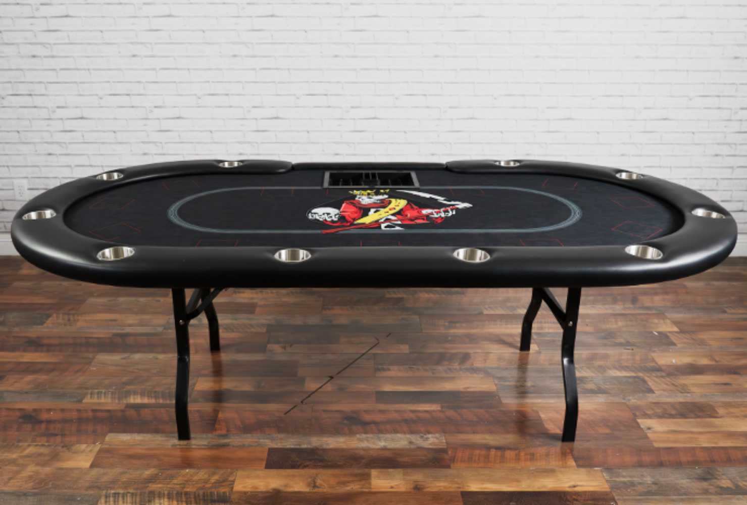 A full view of the BBO Poker Tables Aces Pro Plus Poker Table showcases its black surface with a central skull design and stainless steel cup holders