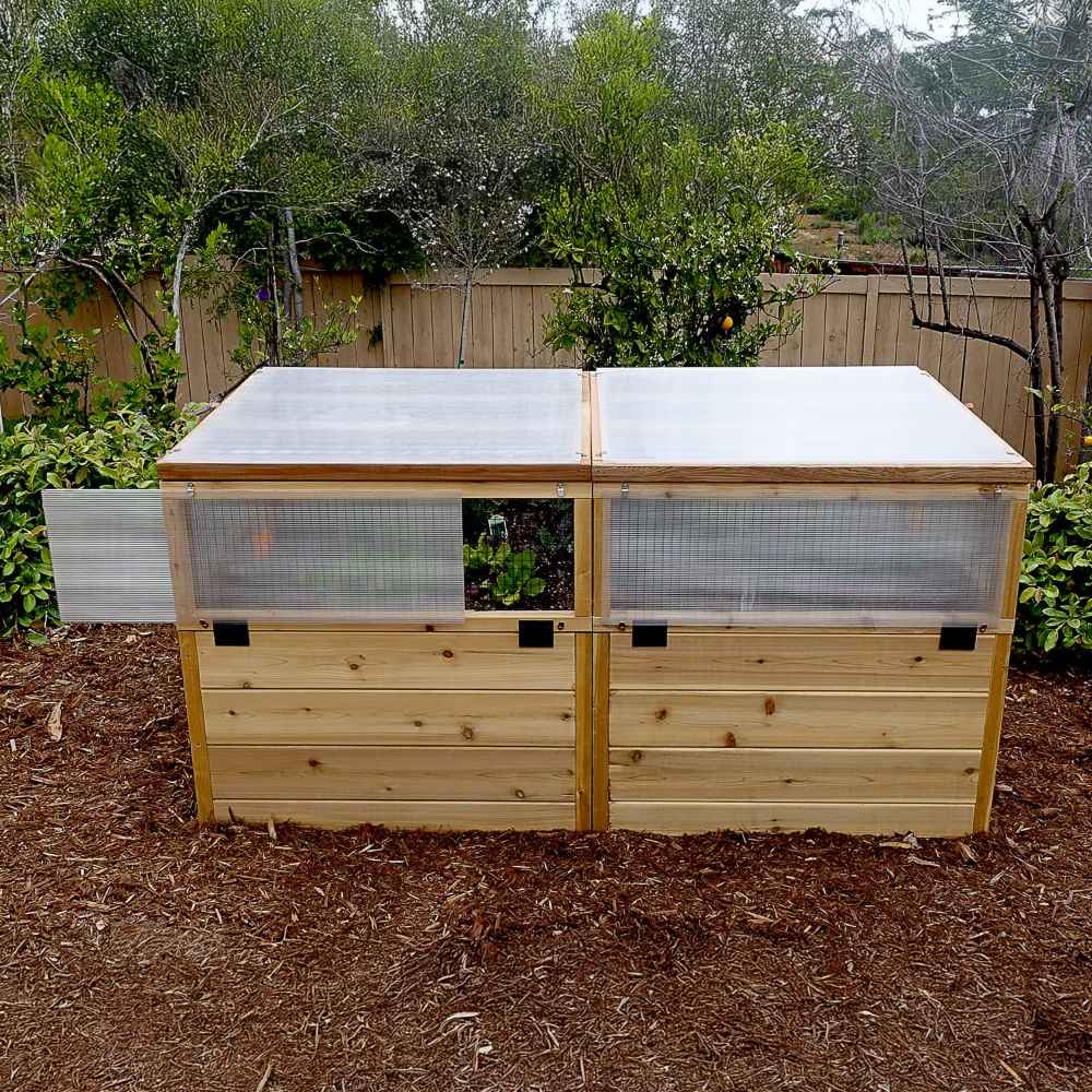 A fully closed structure with translucent lids covering plants shows how the Outdoor Living Today 6×3 Raised Garden Bed protects crops from weather