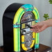 A hand is inserting a USB drive into the Arkrocket Athena Mini Jukebox Tabletop CD Player Bluetooth Speaker (YellowBlack)