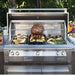 Alfresco Grills 30″ Luxury Grill Built-In in action, showing a variety of grilled vegetables and a rotisserie-cooked roast in an outdoor setting