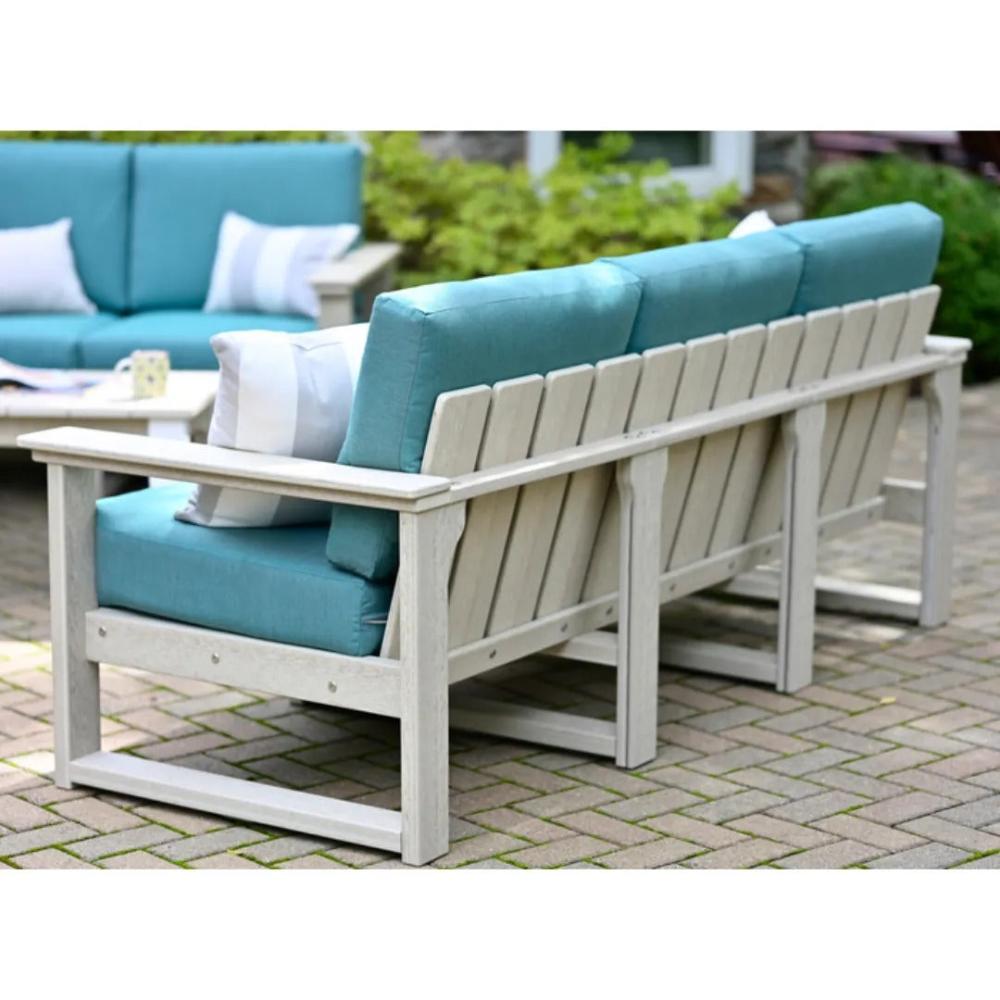 A light-colored poly lumber outdoor sectional with turquoise cushions, highlighting the LuxCraft Armrest and Center Support.