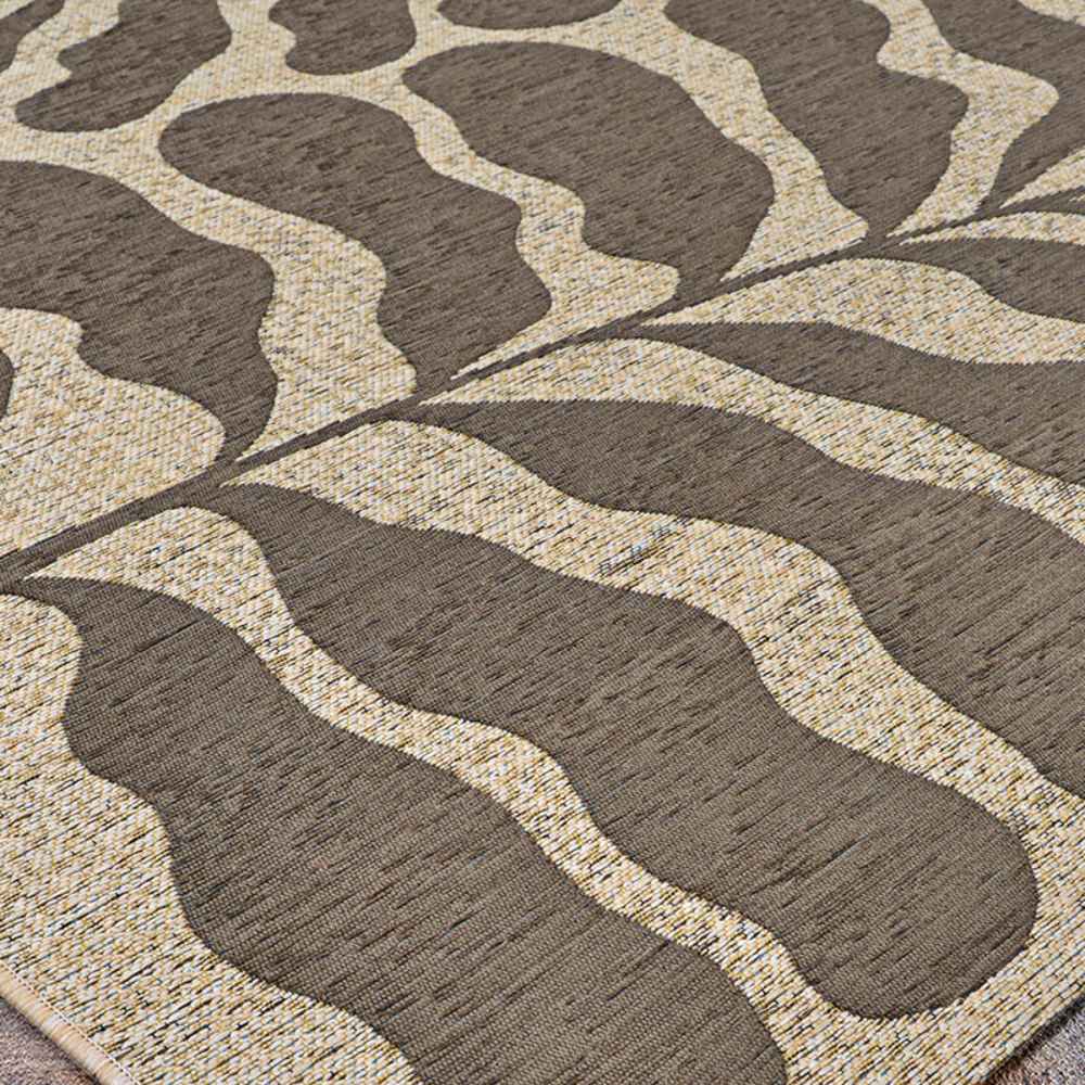 A low-angle shot captures the soft curves and mocha tones of the Couristan Castille Indoor/Outdoor Rug - Fiore/Mocha up close