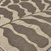 A low-angle shot captures the soft curves and mocha tones of the Couristan Castille Indoor/Outdoor Rug - Fiore/Mocha up close
