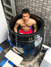 A man sits immersed in the Dreampod Cold Plunge Barrel with Chiller