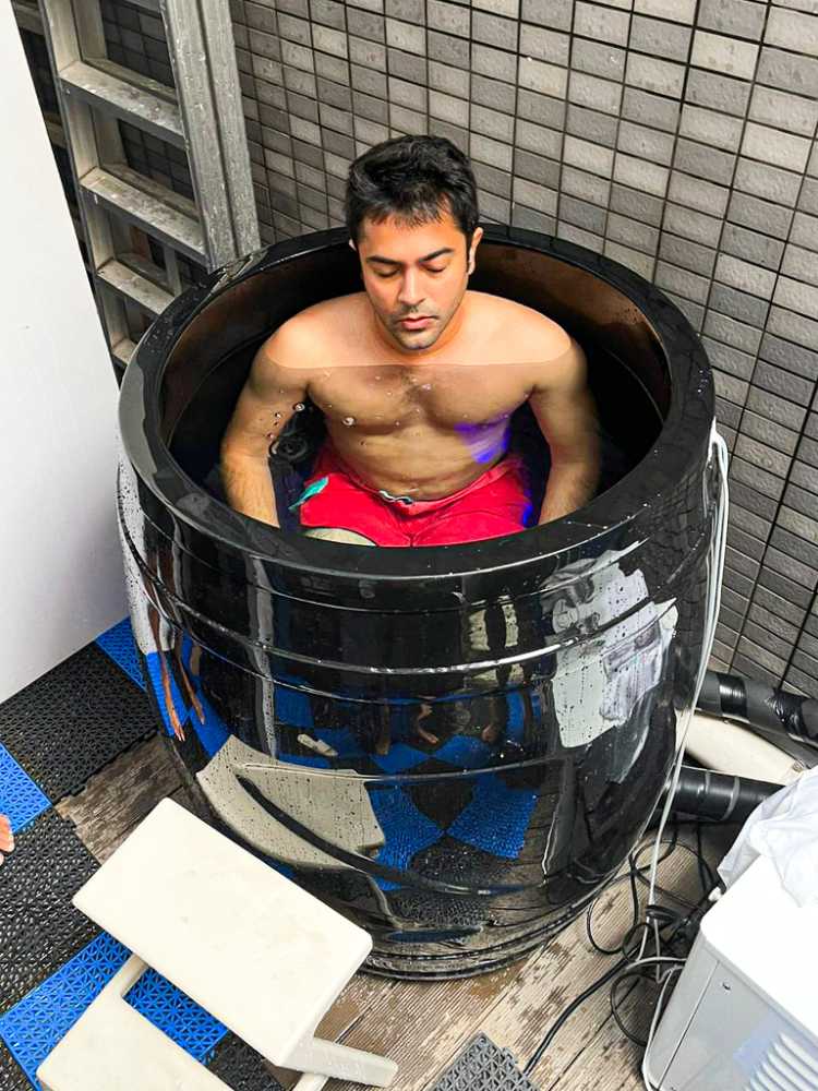 A man sits immersed in the Dreampod Cold Plunge Barrel with Chiller