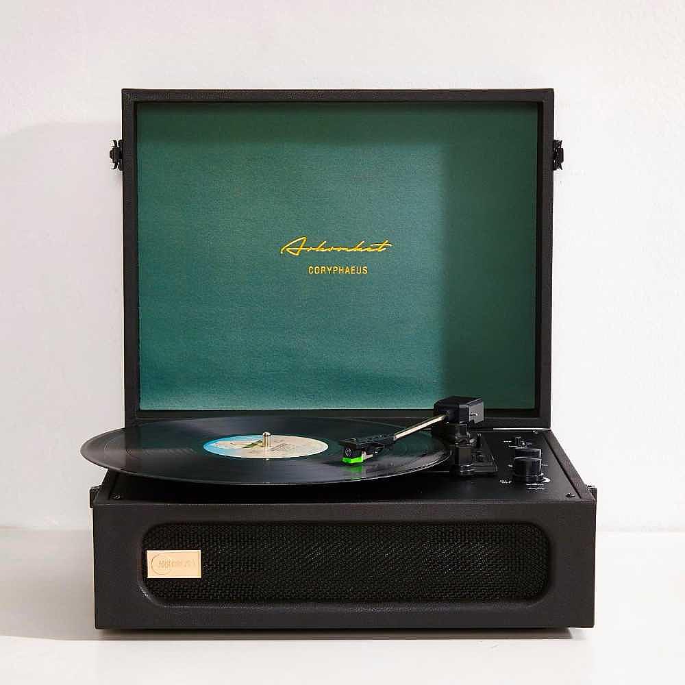 A minimalist close-up of Arkrocket Coryphaeus Bluetooth Turntable Deluxe Edition Record Player (BlackGreen) shows the player open and playing a record