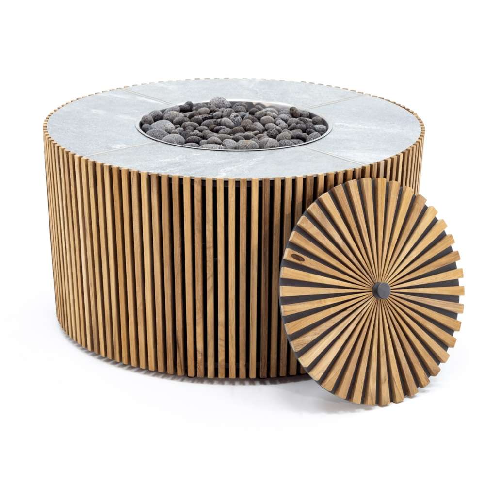 An angled view of Westminster Teak Agora Fire Table shows the ceramic slate top and round lava rock fire bowl