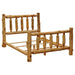 An angled view of the Fireside Lodge Voyageur Traditional Bed - Assembled shows the full wooden log frame with headboard, footboard, and slats