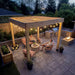 An evening backyard scene with seating, fire feature, and the Outdoor Living Today Western Red Cedar Urban Escape Pergola
