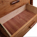 An open drawer of the Fireside Lodge Hickory Log Five Drawer Chest shows a smooth natural wood interior with visible grain