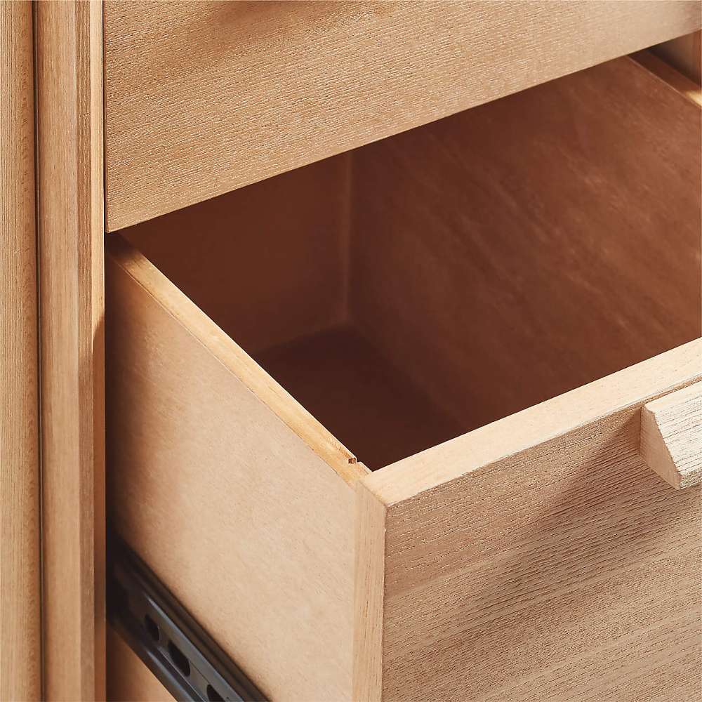 An open storage drawer of Crate & Barrel Elias 66" Natural Elm Wood Desk with File Cabinet shows its spacious interior for office essentials