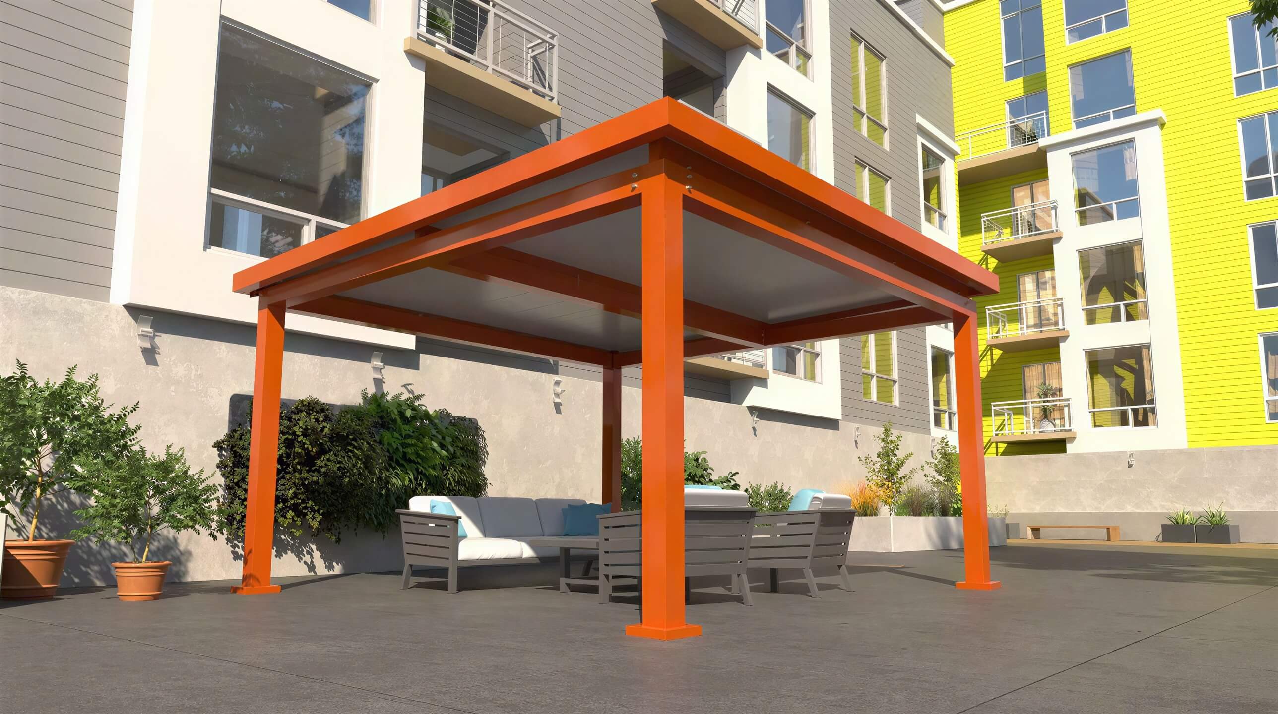An orange Structureworks Pavilion Trex Pergola is set on a patio with outdoor seating, in front of a colorful apartment building