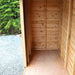An empty wooden shed interior with plank walls and floor highlights the spacious interior of the Outdoor Living Today GardenSaver 12×4 with Sliding Doors