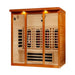 Angled from the left, Golden Designs Dynamic Vila Grande 4 Person Full Spectrum Near Zero EMF Far Infrared Sauna shows its cedar side wall, glass doors and carbon panels inside