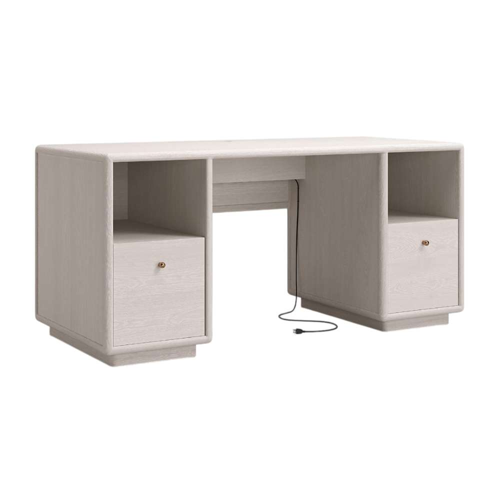 Angled front view of Crate & Barrel Lafayette 64" Whitewashed Desk with Outlets with closed drawers and visible power cord
