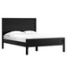 Angled view of Crate & Barrel Keane Black Solid Wood Queen Bed with a clean-lined black wood frame and white bedding